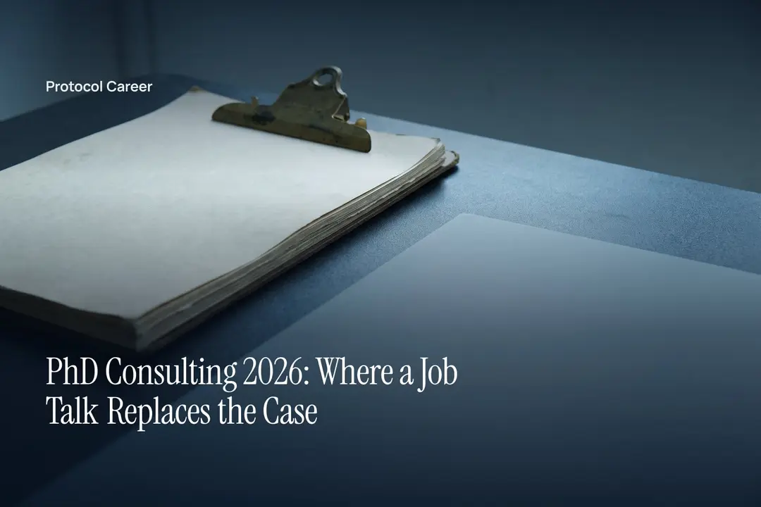 A thick stack of blank cream papers clipped together rests on a dark matte surface in soft light. Title: “PhD Consulting 2026: Where a Job Talk Replaces the Case”, over the Protocol Career wordmark.