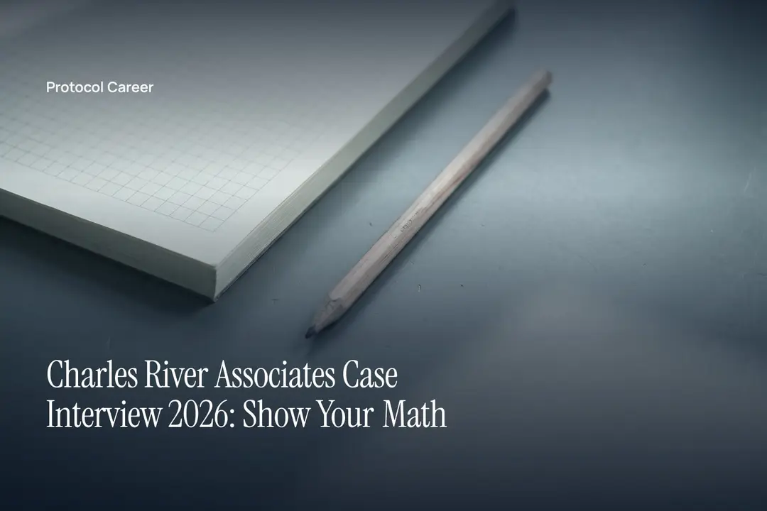 A blank grid notepad and a wooden pencil sit on a smooth gray surface in soft light. Title: “Charles River Associates Case Interview 2026: Show Your Math”, over the Protocol Career wordmark.