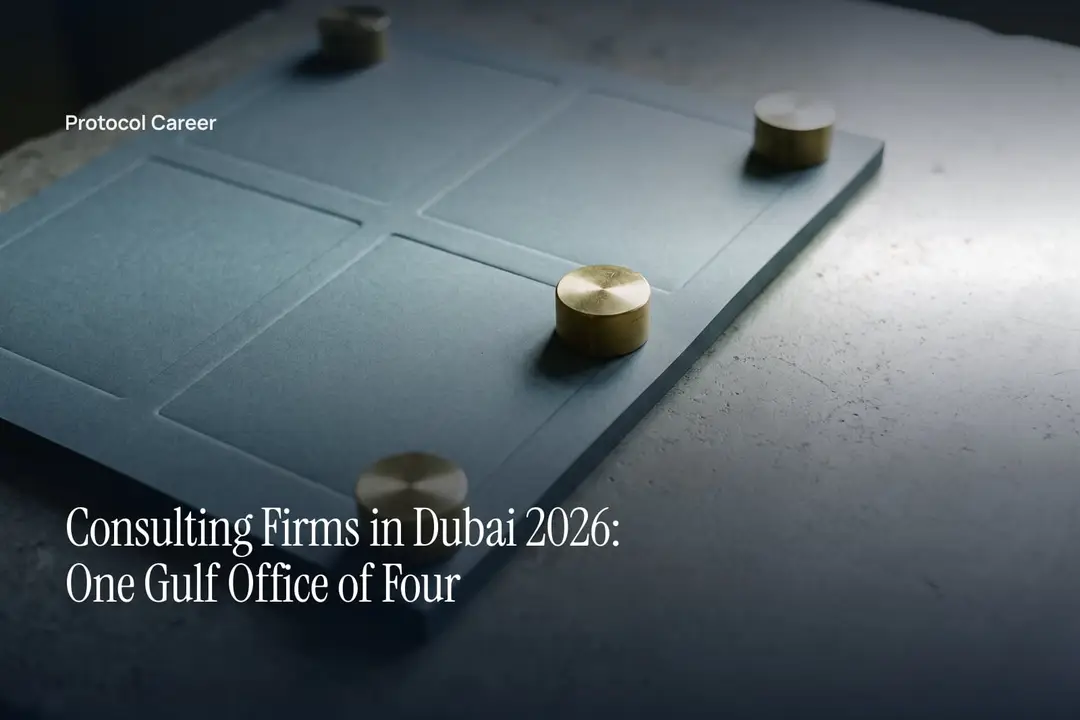Four brass cylinders placed on a heavy card debossed into four blank sections on stone. Title: “Consulting Firms in Dubai 2026: One Gulf Office of Four”, over the Protocol Career wordmark.