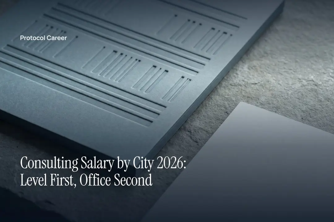 A thick cream paper card with blind-debossed horizontal tiers resting on a soft grey stone surface. Title: “Consulting Salary by City 2026: Level First, Office Second”, over the Protocol Career wordmark.