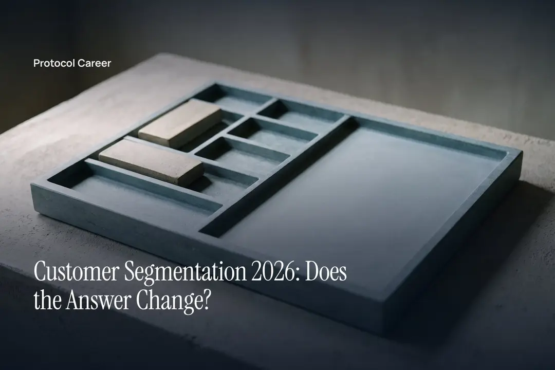 A partitioned stone tray with two neutral blocks in the upper corner on a plain plaster surface. Title: “Customer Segmentation 2026: Does the Answer Change?”, over the Protocol Career wordmark.