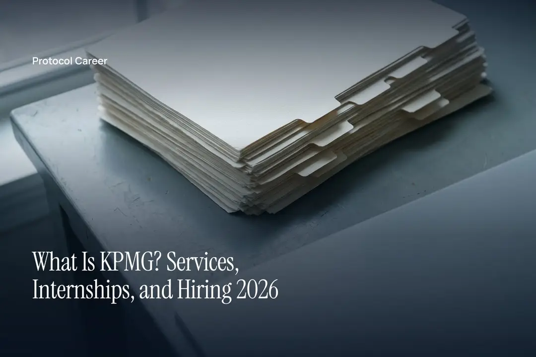 A thick stack of blank cream documents with stepped index tabs sits on a minimalist matte desk. Title: “What Is KPMG? Services, Internships, and Hiring 2026”, over the Protocol Career wordmark.