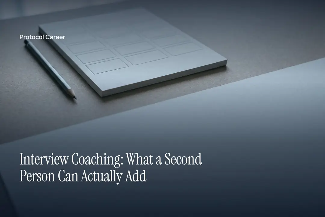 A blank debossed grid scorecard and a graphite pencil lie on a neutral grey desk in soft light. Title: “Interview Coaching: What a Second Person Can Actually Add”, over the Protocol Career wordmark.