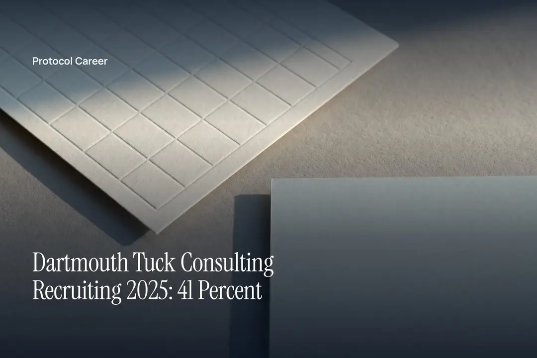 A heavy cream card debossed with a blank schedule grid lies on a plain grey surface. Title: “Dartmouth Tuck Consulting Recruiting 2025: 41 Percent”, over the Protocol Career wordmark.
