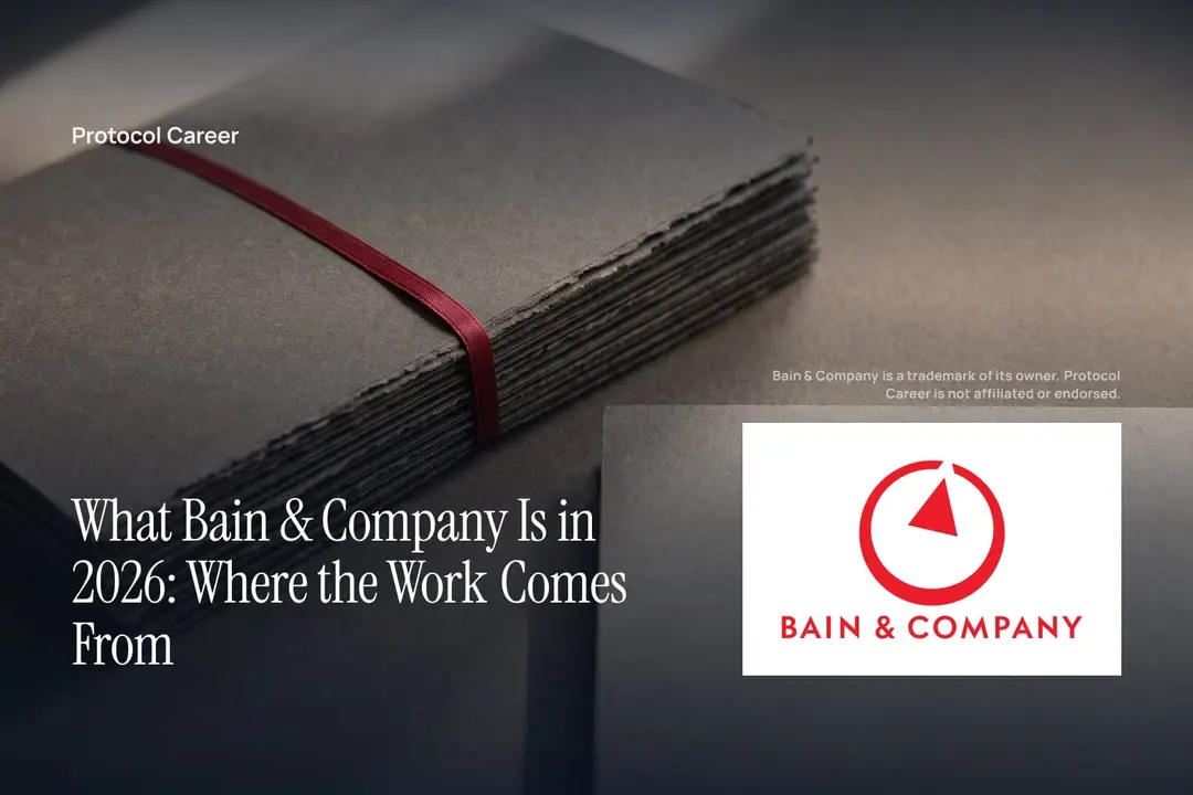 A stack of blank charcoal paper dossiers tied with a red ribbon on a dark matte surface. Title: “What Bain & Company Is in 2026: Where the Work Comes From”, over the Protocol Career wordmark. Bain & Company logo, lower right.